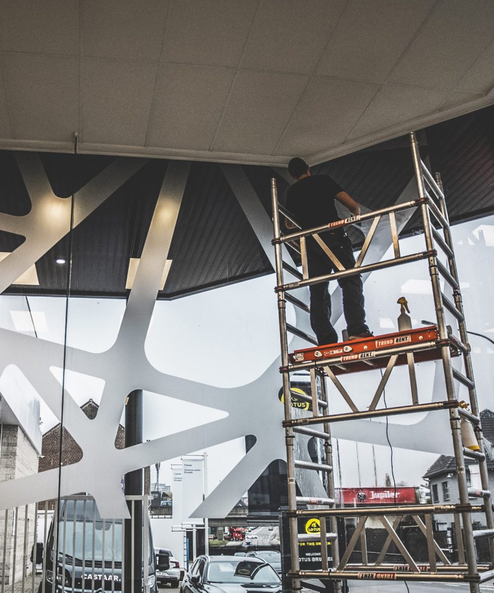 Plaatsing raamstickers voor Lotus showroom